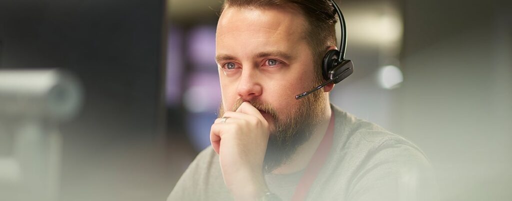 man with headset concentrating, managed it services perth
